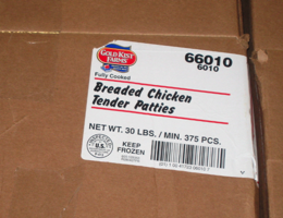 Boxes of breaded chicken patties, no longer welcome in Minneapolis Public Schools, still line the walls of the distribution center 